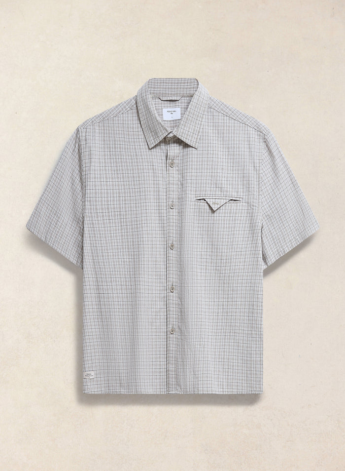 The Percival Hinsley boxy short sleeve shirt in cream check cotton, featuring a unique geometric chest pocket.