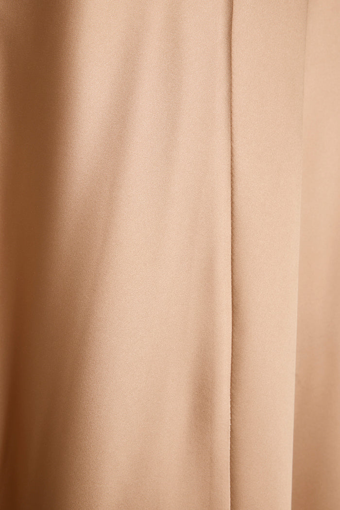 Close-up of champagne satin fabric on the Mirabella maxi dress, showing seam and soft sheen.