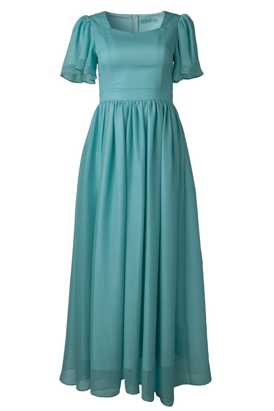 The Abbie Dress in Seaglass Chiffon by Ivy City Co features short puffed sleeves, a fitted bodice, gathered skirt, and square neckline—an airy, light blue choice perfect for fall bridesmaids.
