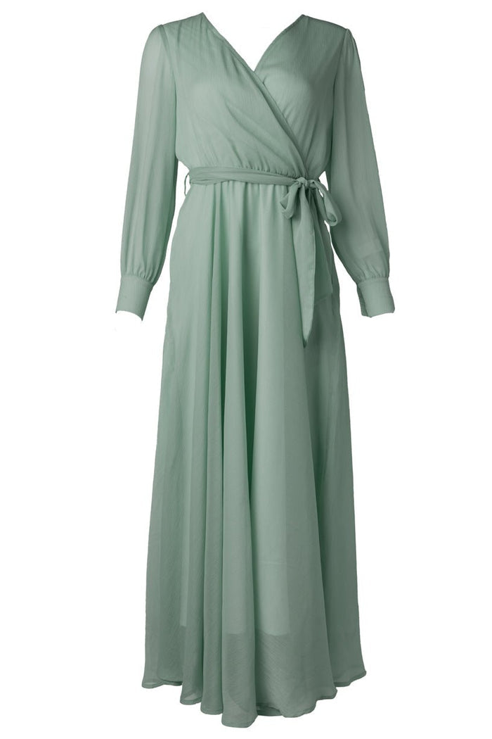 The Andie Dress in Sage by Ivy City Co is a long, light green maxi dress featuring long sleeves, a V-neckline, and a matching fabric belt at the waist—ideal for an elegant bridesmaid look or as a comfortable maternity wedding guest dress.