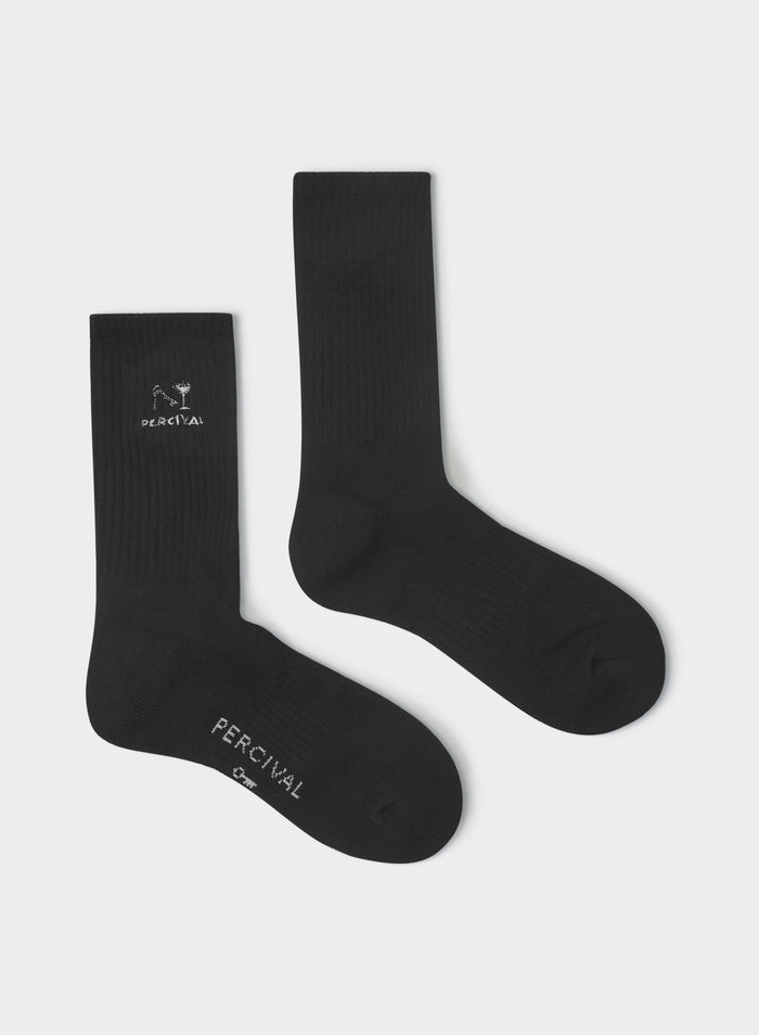 Black Percival Aperitivo socks in ribbed cotton with white cocktail glass embroidery and logo, shown as a flat lay.
