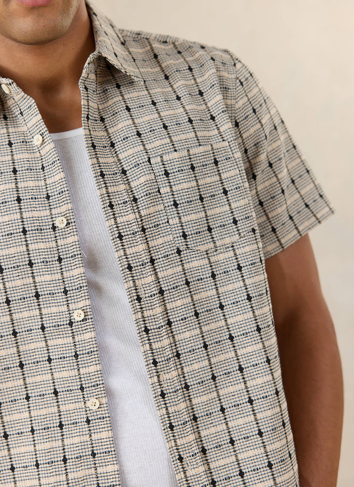 Close-up of the textured Percival Bayley check shirt in cream cotton, showcasing the geometric pattern.