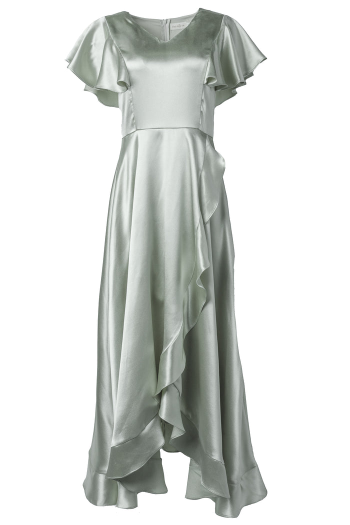 The Callie Dress in Sage Satin by Ivy City Co features flutter sleeves, a fitted waist, and an asymmetrical ruffled hem in soft, shiny fabric—an elegant choice for any bridal party.