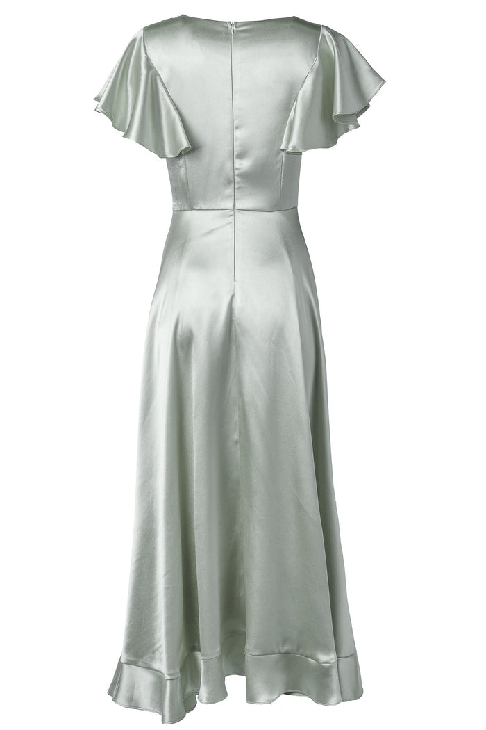The Callie Dress in Sage Satin by Ivy City Co is a light sage green bridesmaid dress featuring short flutter sleeves, a fitted bodice, flared skirt, back zipper closure, and ruffled details on the hem and sleeves.