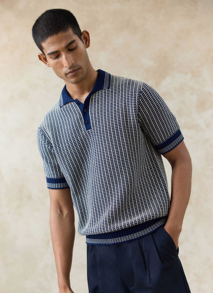 Navy Percival Claude Knitted Polo worn by a model, showing the two-tone textured cotton knit and three-button placket.