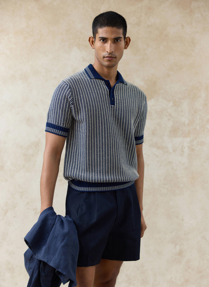 Percival Claude Knitted Polo in navy, featuring a two-tone textured cotton knit and ribbed collar, worn by a model.