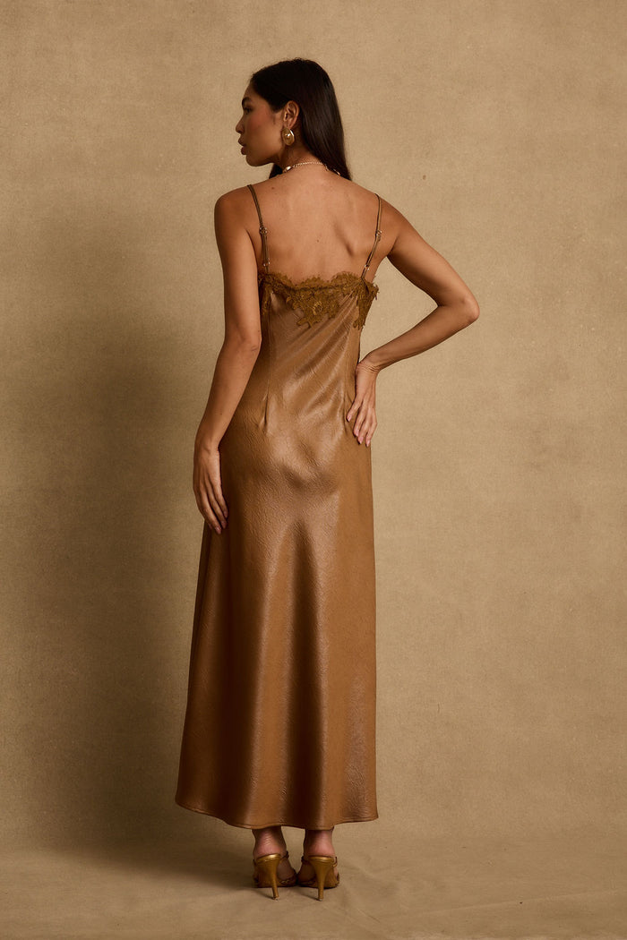 Back of the Cordon bronze satin maxi dress, lace-trimmed open back and gold heels.