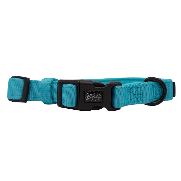 Part of the Sassy Woof Dog Collar Three Piece Bundle in Neon Blue, this adjustable collar features a striking turquoise hue, a secure black plastic buckle, durable D-ring, and the signature Sassy Woof logo tag on the front—making it a standout accessory for pups who love vibrant color.