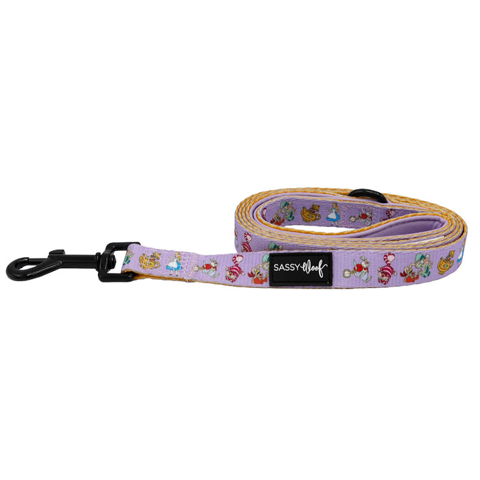 The Sassy Woof Dog Leash - Alice in Wonderland (Purple) features colorful cartoon animal faces, a black metal clip, and a padded neoprene handle.