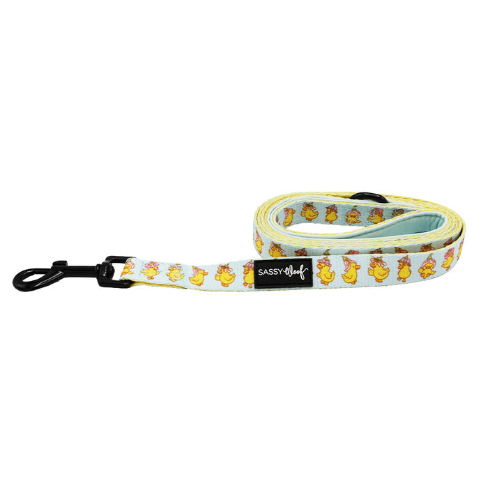 The Sassy Woof Dog Leash - Good Duck, Babe! features a neoprene handle, black metal clip, and a fun duck design with yellow chicks and brown bunnies on white, plus the Sassy Woof label.