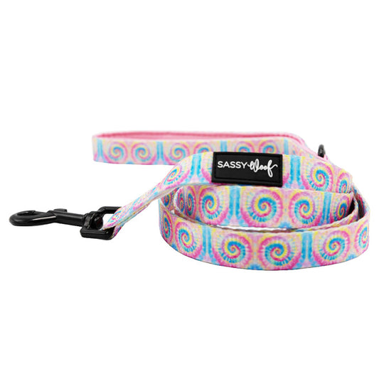 The Dog Leash - Good Vibes by Sassy Woof features a pastel tie-dye swirl, padded handle with “SASSY WOOF” label, and black metal clasp. The leash is coiled and displayed on a white background.