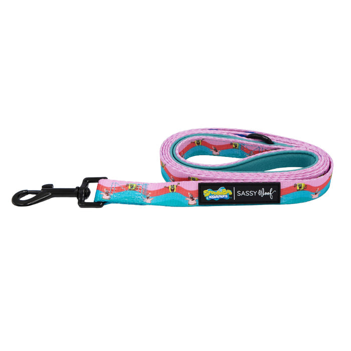 The Sassy Woof Dog Leash - SpongeBob SquarePants™ and Friends features a vibrant pink and teal wavy design, black metal clasp, and branded labels for Sassy Woof and SpongeBob SquarePants.