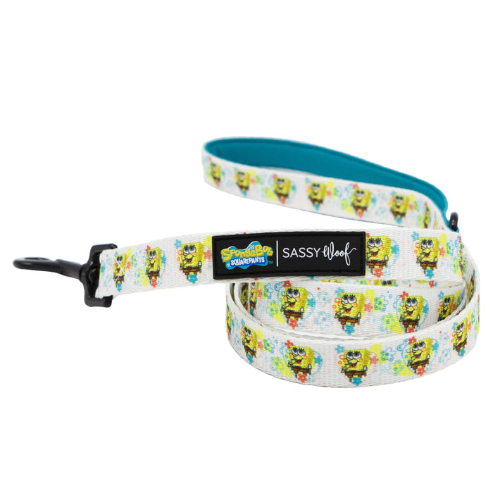 The Sassy Woof Dog Leash - SpongeBob SquarePants™ Bikini Bottom features colorful character graphics, a soft neoprene handle, and a black Sassy Woof label—ideal for fans looking to match their dog accessories. Shown coiled on a white background.