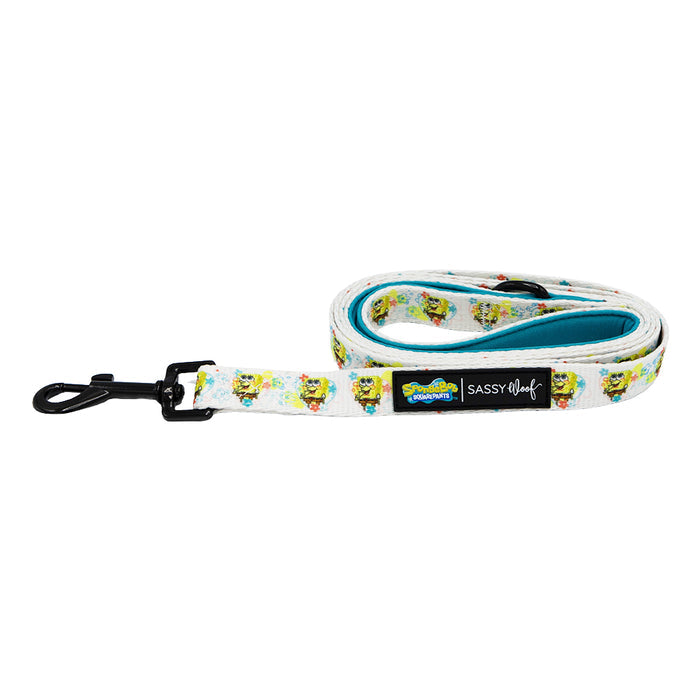The Sassy Woof Dog Leash - SpongeBob SquarePants™ Bikini Bottom features a white leash with vibrant SpongeBob patterns, logos from Sassy Woof and SpongeBob, a black metal clasp, teal neoprene handle, and coordinates with matching accessories.