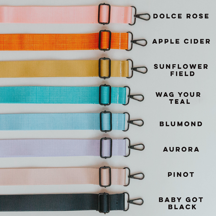 The Sassy Woof Dog Parent Bag + Strap comes with eight adjustable, interchangeable straps in pink, orange, yellow, teal, blue, light green, light purple, and black—ideal for customizing your look. Strap colors are listed on the right.