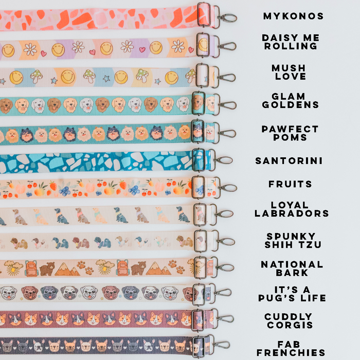Twelve vibrant Sassy Woof dog collars featuring breed illustrations are displayed vertically, each labeled. Perfectly pairs with the Dog Parent Bag + Strap for added convenience and style.