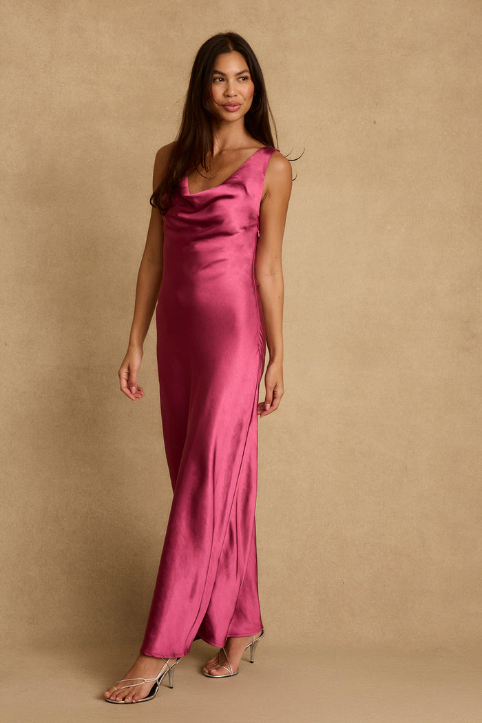 Fuchsia satin maxi dress with cowl neckline, worn on-model with silver strappy heels.