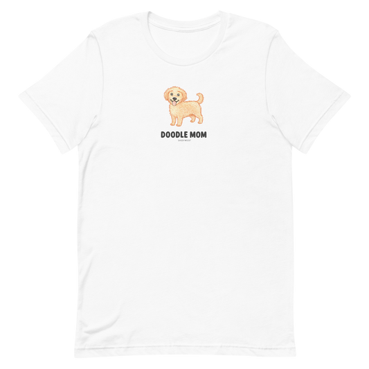The Sassy Woof Doodle Mom Tee is a white unisex shirt featuring a cartoon doodle dog and "DOODLE MOM"—perfect for any proud Doodle Mom t-shirt collector.