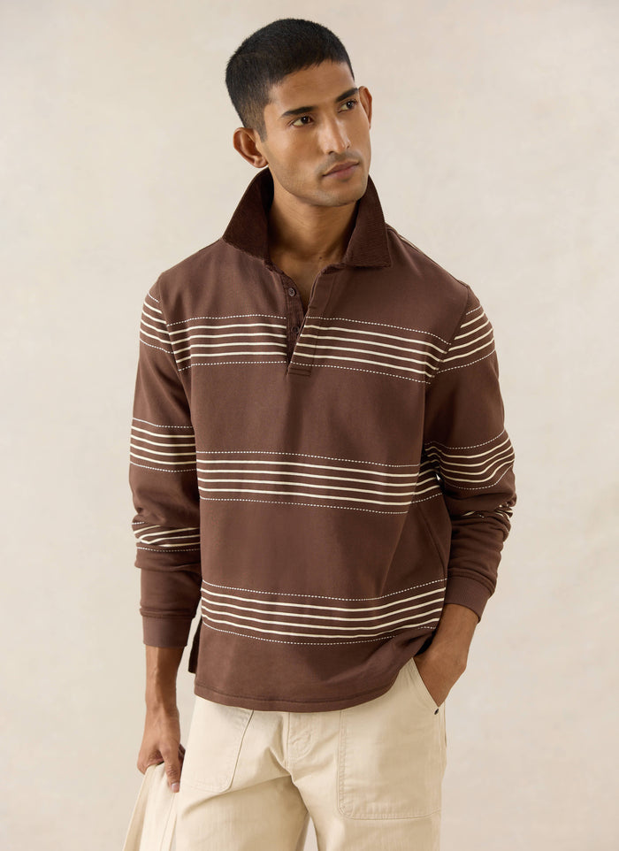 Percival Editor Striped Rugby Polo in espresso with a cord collar and stab stitching, worn with Lucas carpenter pants.