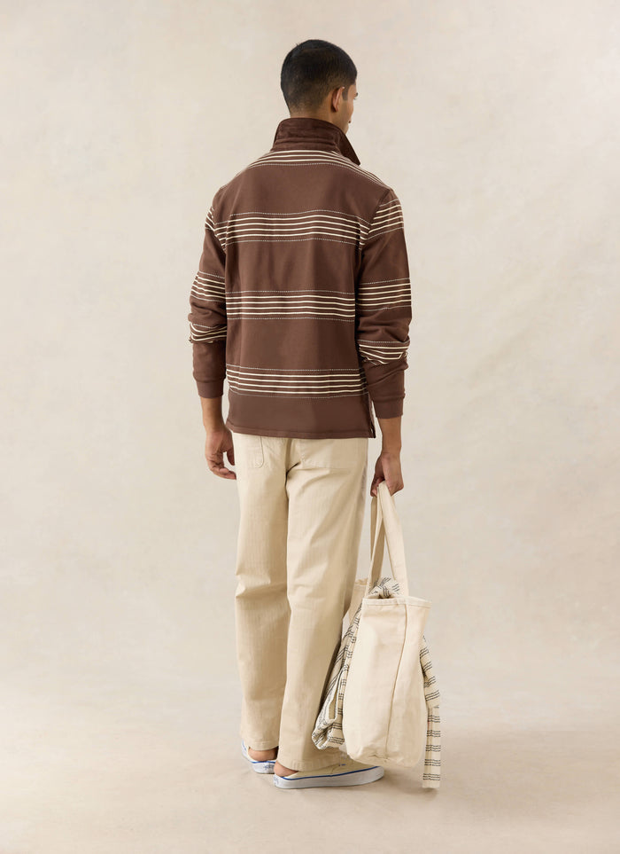 The Percival Editor Rugby Polo in espresso with embroidered stab stitching and cord collar, shown from the back.