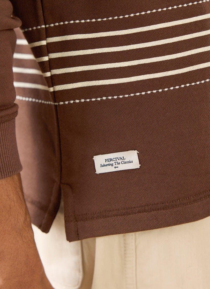 The Percival Editor Striped Rugby Polo in espresso cotton, featuring white horizontal stripes and stab stitching.