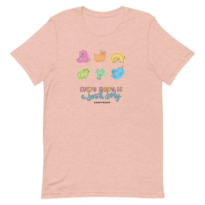 The Sassy Woof Every Body is a Beach Body Tee is a light pink, comfy unisex shirt with colorful cartoon dogs above the playful phrase "Everybody is a good body," and SASSYWOOF underneath—perfect for celebrating every beach body!.