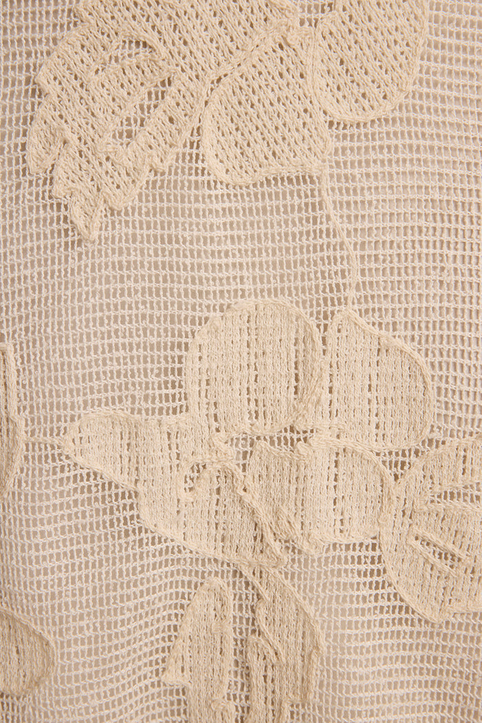 Close-up of ivory embroidered mesh fabric with raised floral crochet detail on the Fontaine midi dress.