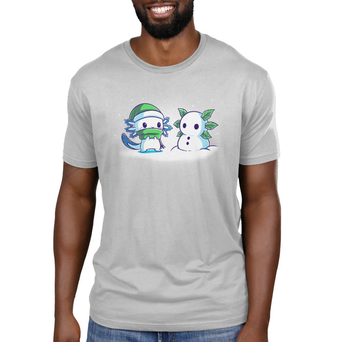 Premium Cotton T-shirt_TeeTurtle Frosty Friend A cute, blue cartoon creature with a green hat and scarf stands next to its Frosty Friend, a snowman with leaf arms, in a snowy setting.