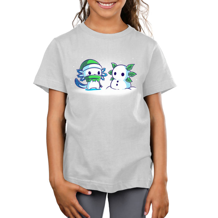 Premium Cotton T-shirt_TeeTurtle Frosty Friend A cute, blue cartoon creature with a green hat and scarf stands next to its Frosty Friend, a snowman with leaf arms, in a snowy setting.