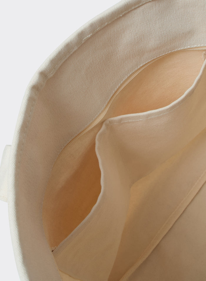 Interior of the cream cotton Percival Gordon Large Tote Bag, highlighting the functional internal storage pockets.