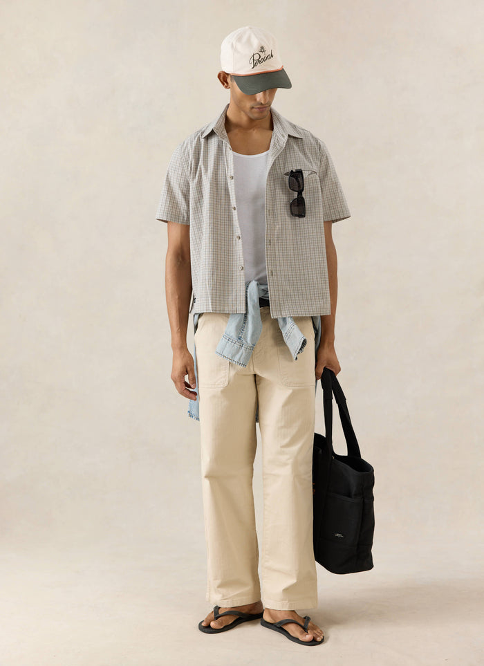 The Percival Hinsley short sleeve boxy cotton shirt in cream check, styled with a Spencer cap and Lucas trousers.