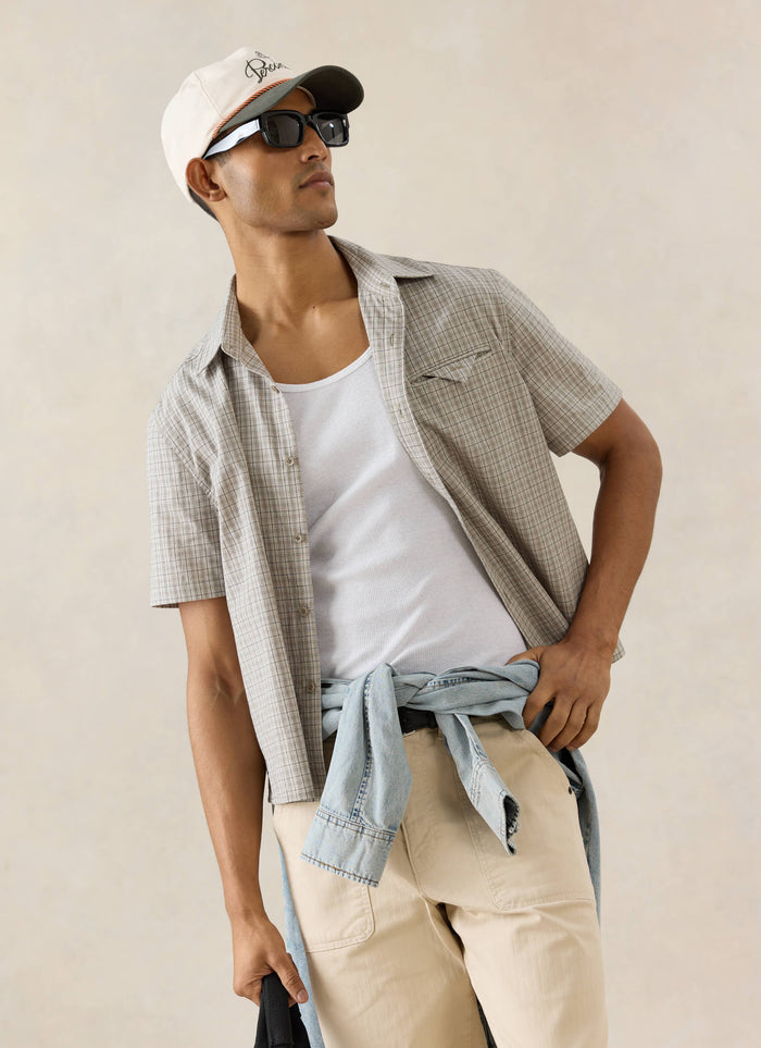 Percival Hinsley cream check boxy shirt styled with a Spencer rope detail cap and Lucas carpenter trousers.