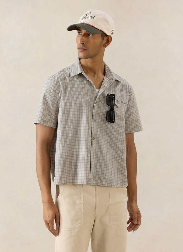 Percival Hinsley boxy short sleeve shirt in cream check cotton, styled with a Spencer cap and Lucas trousers.