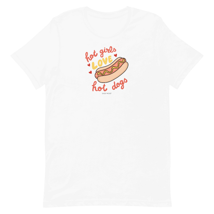 The Sassy Woof Hot Girls Love Hot Dogs Tee is a white unisex t-shirt with a fun hot dog graphic and playful “hot girls love hot dogs” text in red and orange, printed using eco-friendly ink.
