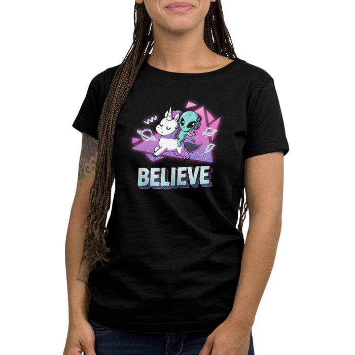 Premium Cotton T-shirt_TeeTurtle black I Believe apparel featuring an alien with headphones on riding a unicorn with a geometric neon 90’s background. Caption says, "BELEIVE".