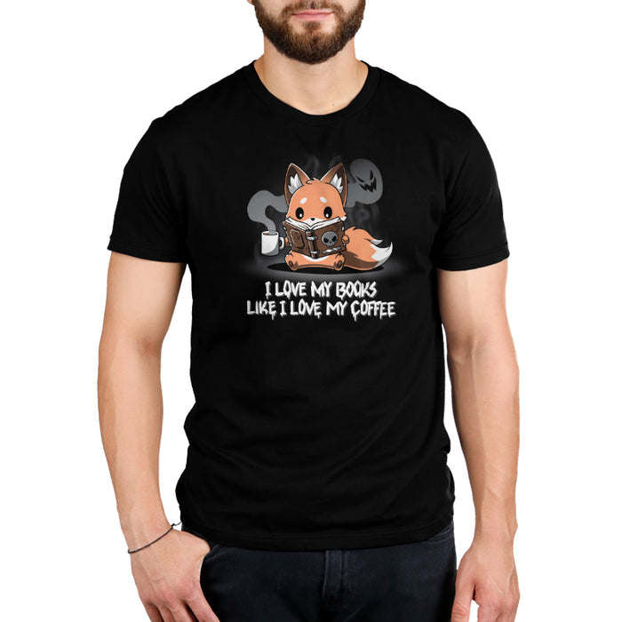 Premium Cotton T-shirt_Teeturtle black I Love My Books Like I Love My Coffee apparel featuring a fox holding a coffee cup with spooky steam and reading a book with a skull on the cover. Text below reads: "I love my books like I love my coffee."
