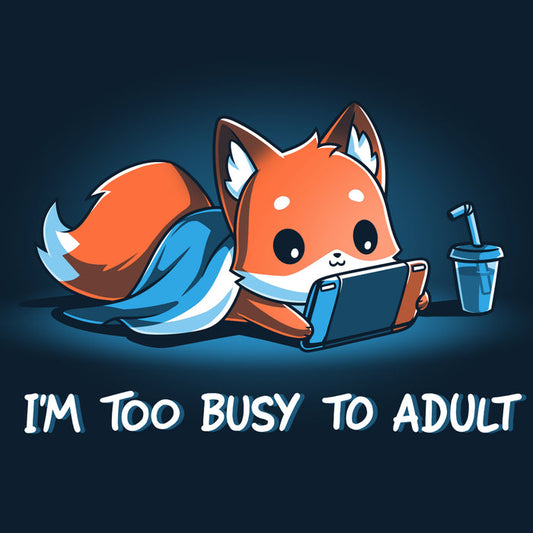 Premium Cotton T-shirt_TeeTurtle I'm Too Busy to Adult navy blue t-shirt featuring a fox lying down with a blue blanket, holding a video game tablet, next to a drink with a straw. Text below reads, "I'M TOO BUSY TO ADULT."