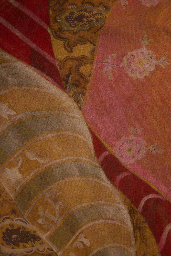 Close-up of Isabella patchwork maxi dress chiffon in pink, mustard, and red floral prints.