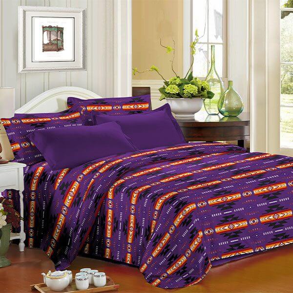 King 4pc Sheet Set – Purple displayed on a bed with a vibrant Navajo print, enhancing bedroom decor and comfort.