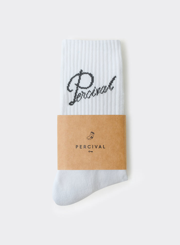 White Percival Kingsley Jacquard Socks in a ribbed cotton blend, with a black script logo and brown paper packaging.