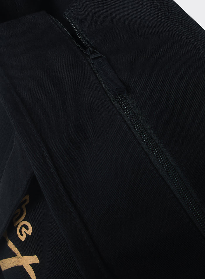 Close-up of the black cotton Percival Kingsley Large Tote Bag, highlighting the zip fastening and durable canvas weave.