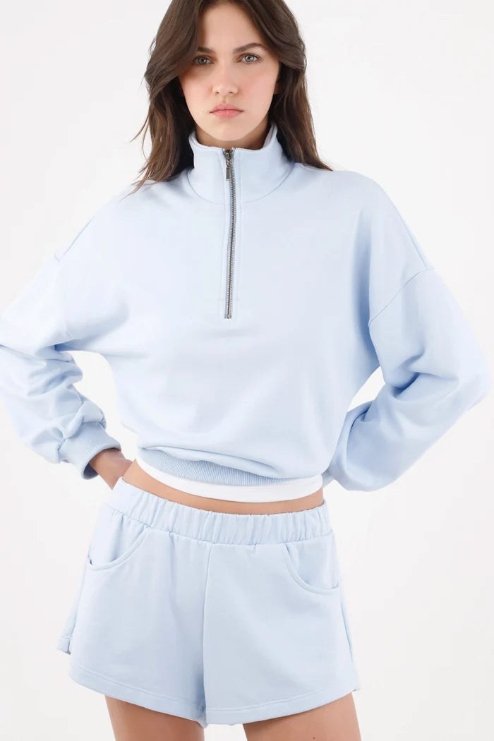 Light blue cotton bermuda shorts for women with a relaxed fit and wide elastic waistband