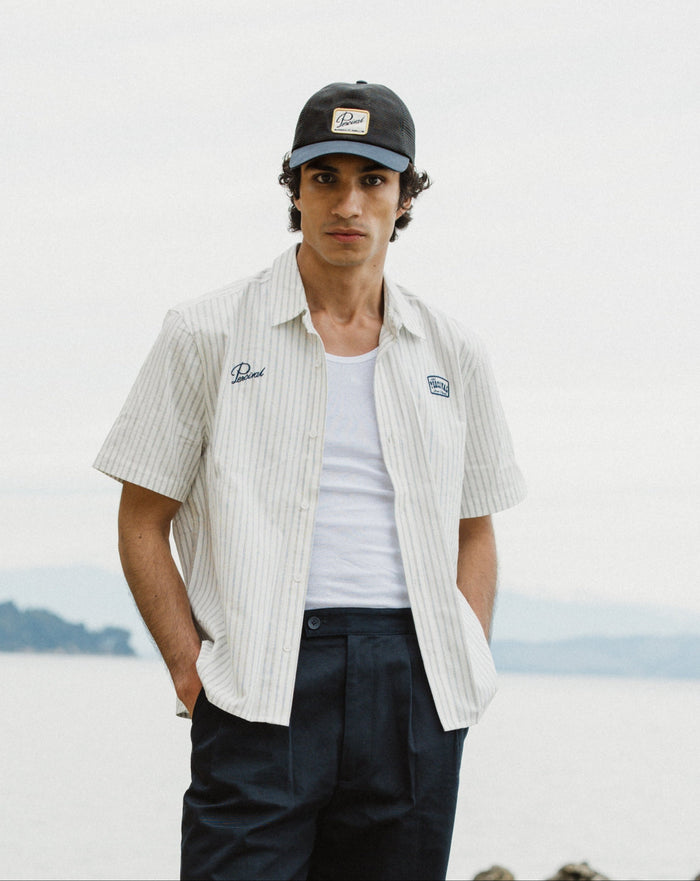 Percival Lucia Embroidered Shirt in cream stripe cotton with a motel chest badge and signature embroidery on a model.