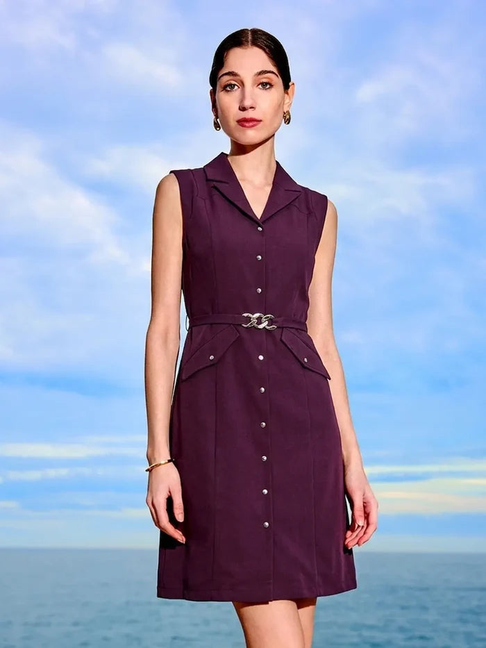 Woman wearing a purple dress against a blue sky and ocean background