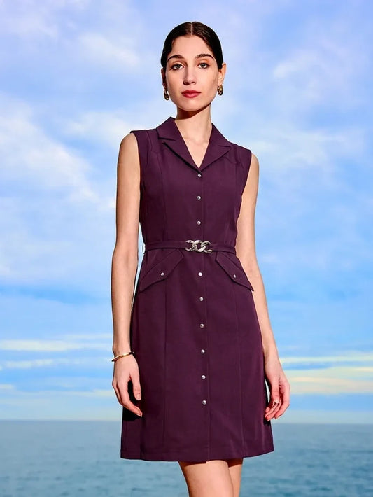 Woman wearing a purple dress against a blue sky and ocean background