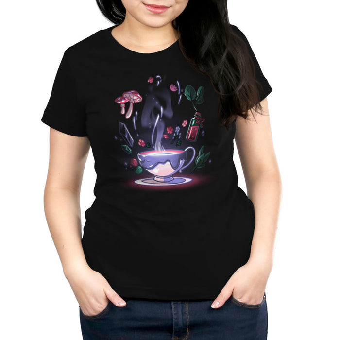Premium Cotton T-shirt_TeeTurtle Mystic Tea black t-shirt featuring a steaming teacup with a dark liquid inside is surrounded by floating magical cottagecore items, including mushrooms, flowers, leaves, crystals, and a small bottle containing a red potion.