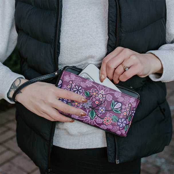 Person holding a purple floral-patterned wallet