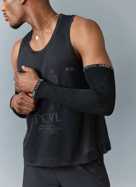 Close-up of a model wearing the black PCVL Arm Compression sleeves and a matching training vest from Percival.