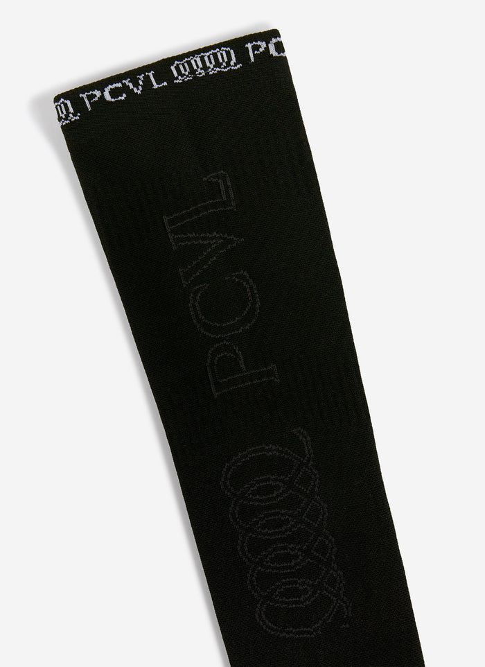 A close-up of the Percival PCVL Arm Compression sleeve in black, showing the detailed white and tonal jacquard branding.