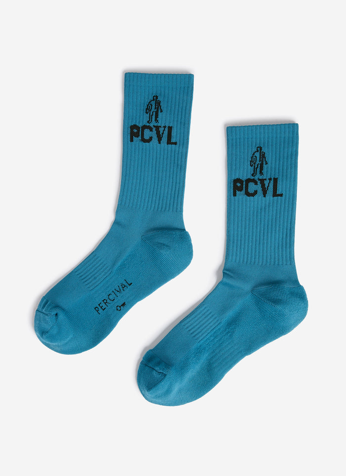 A flat lay of the Percival PCVL Sport Socks in blue, showing the ribbed texture and black jacquard graphic on the cuff.